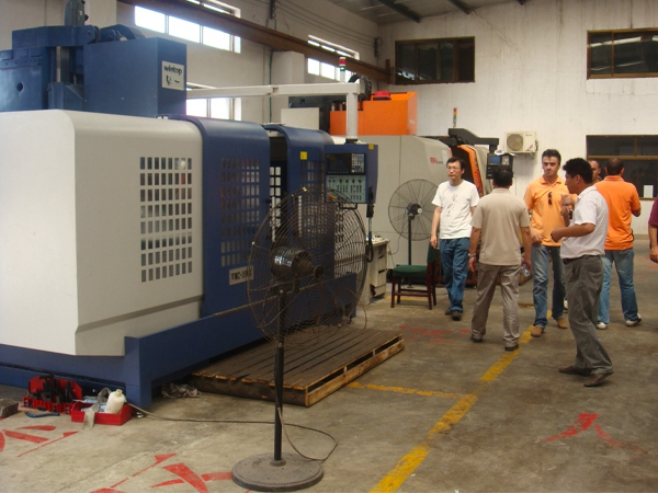 CNC mold machining center in foundry workshop, overseas customers visiting CNC machine tool